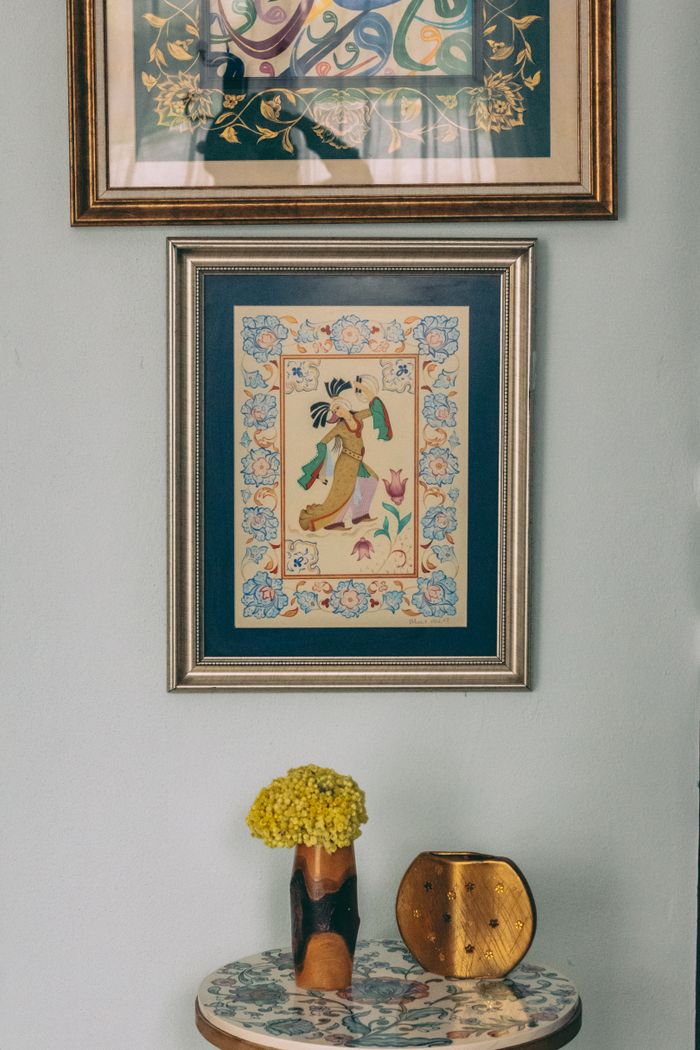 A chic interior with framed art and a decorative table arrangement.